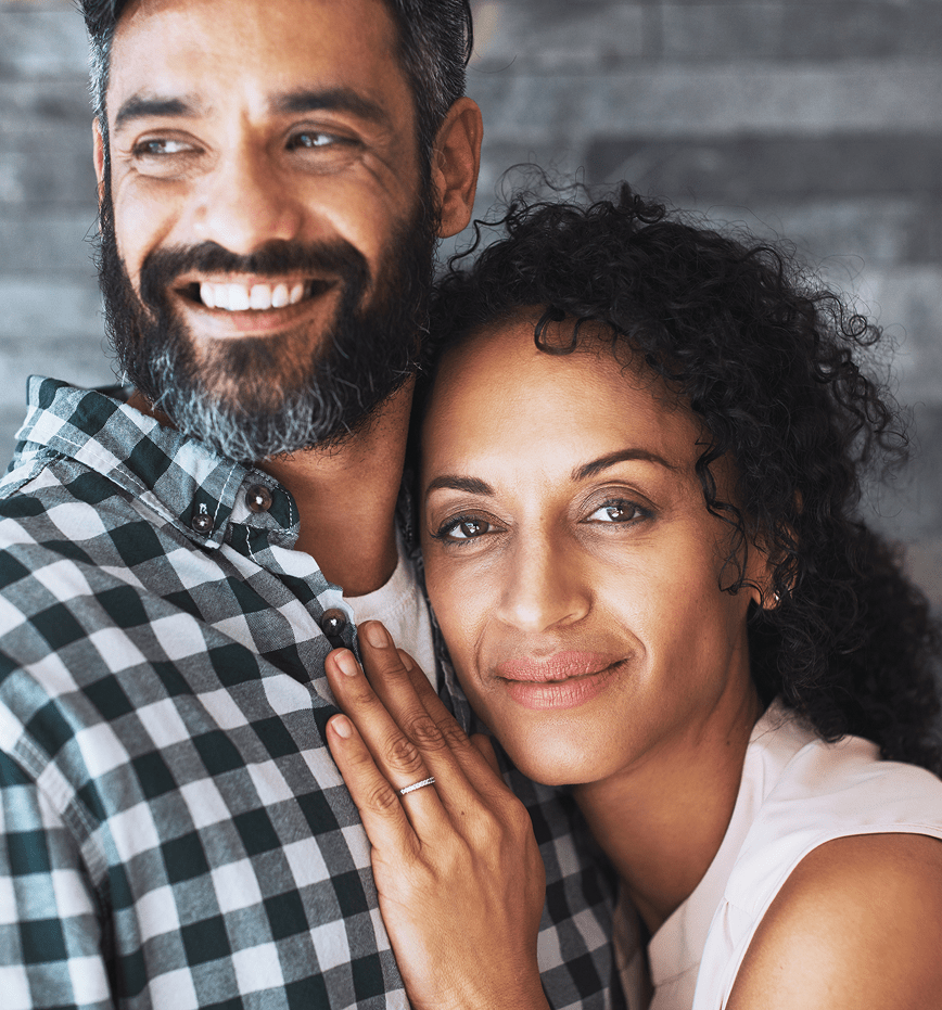 Smiling couple embracing — representing proactive health and colon cancer awareness.