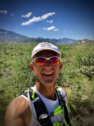 Scott C., a patient who screened with Cologuard, wearing hiking gear outdoors